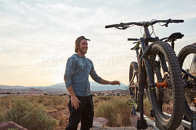 Buy stock photo Shot of a young man out mountain biking during the day