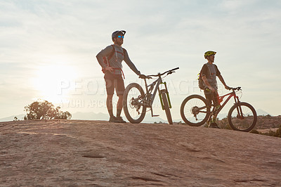 Buy stock photo Full length shot of two men out mountain biking together during the day