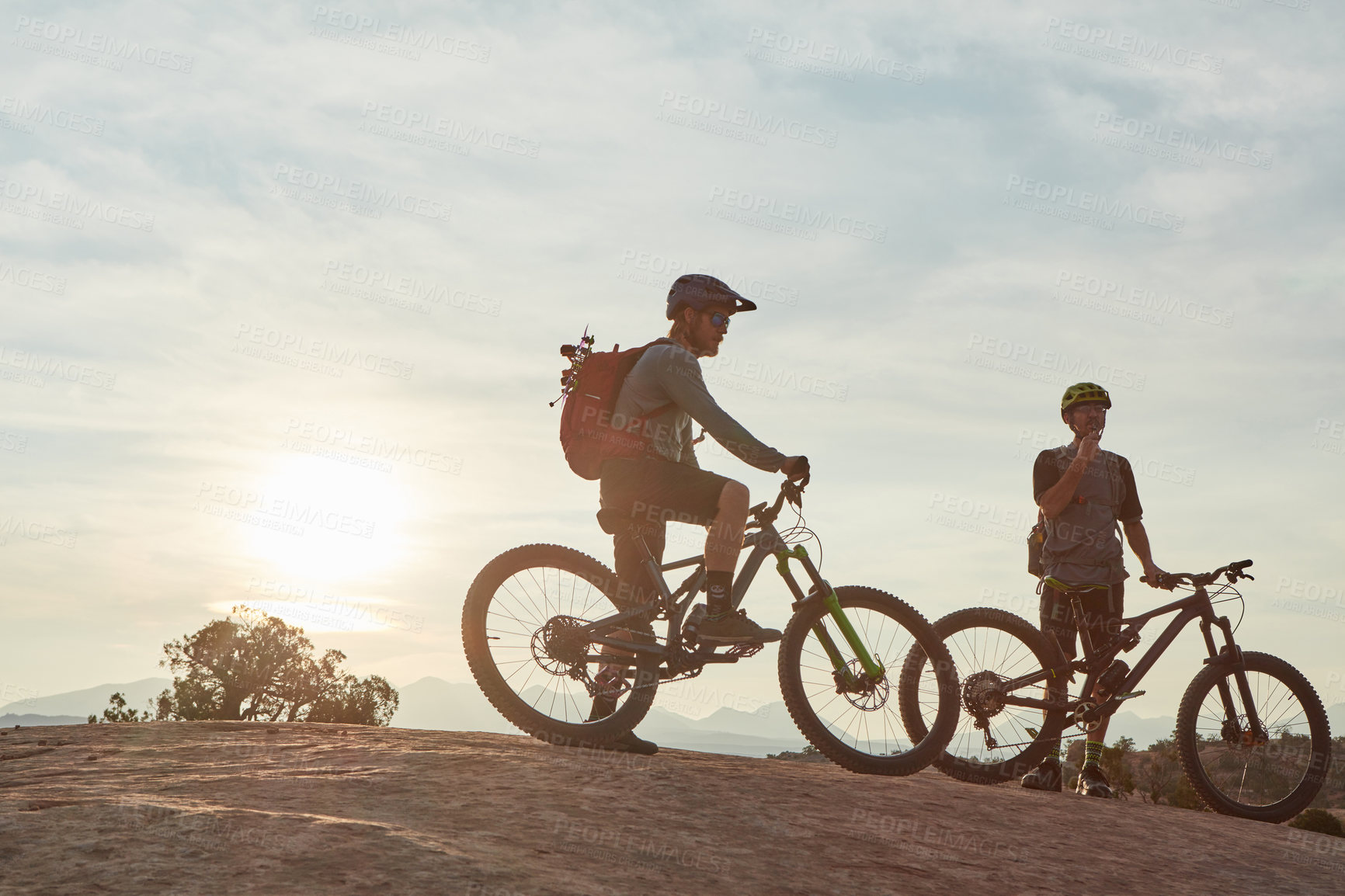 Buy stock photo Full length shot of two men out mountain biking together during the day