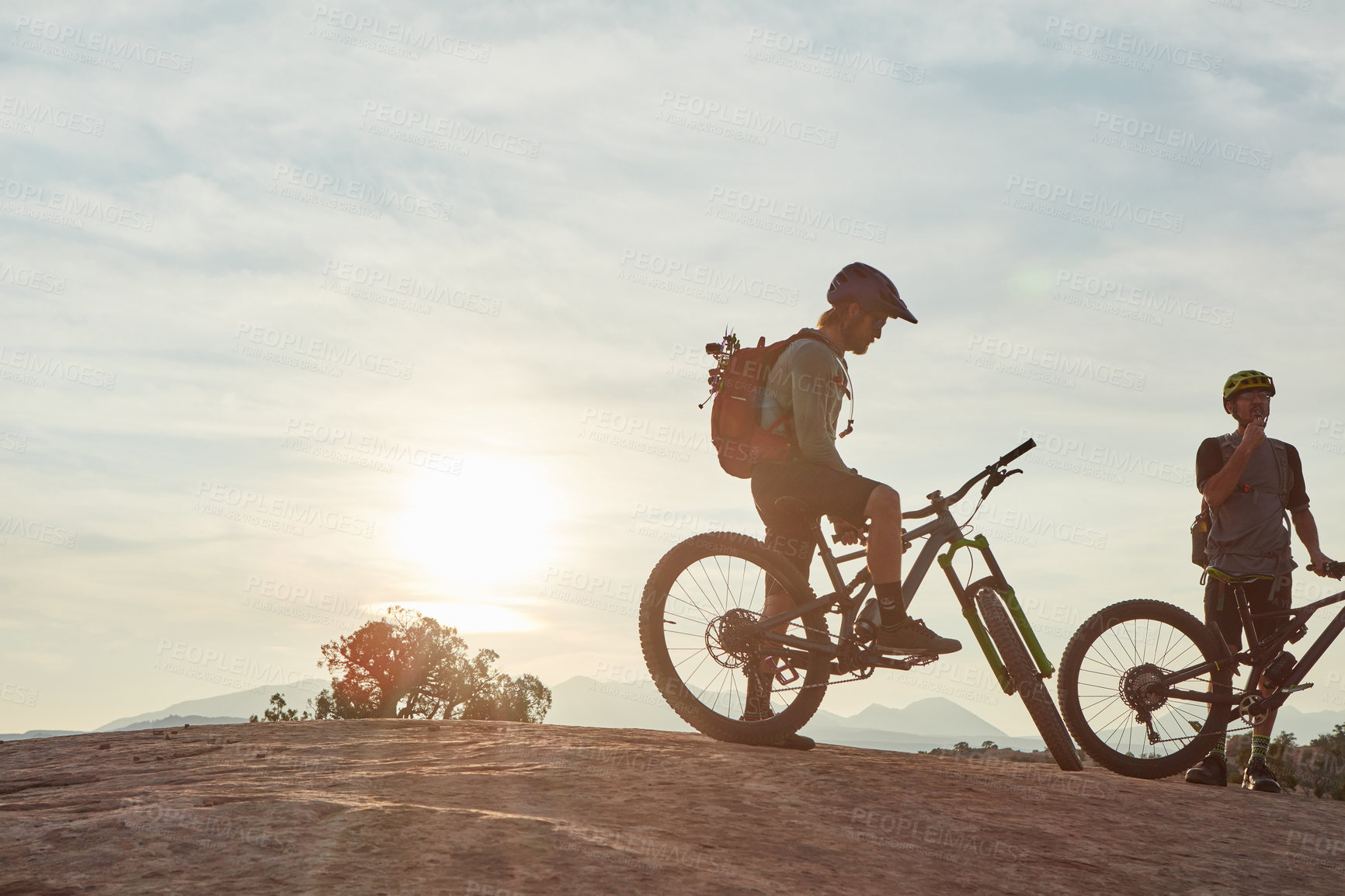 Buy stock photo Full length shot of two men out mountain biking together during the day