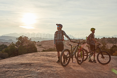 Buy stock photo Full length shot of two men out mountain biking together during the day