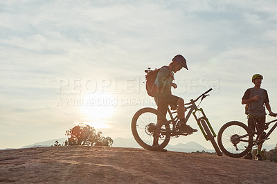 Buy stock photo Full length shot of two men out mountain biking together during the day