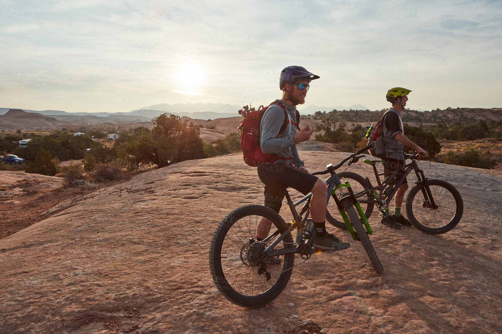 Buy stock photo Full length shot of two men out mountain biking together during the day