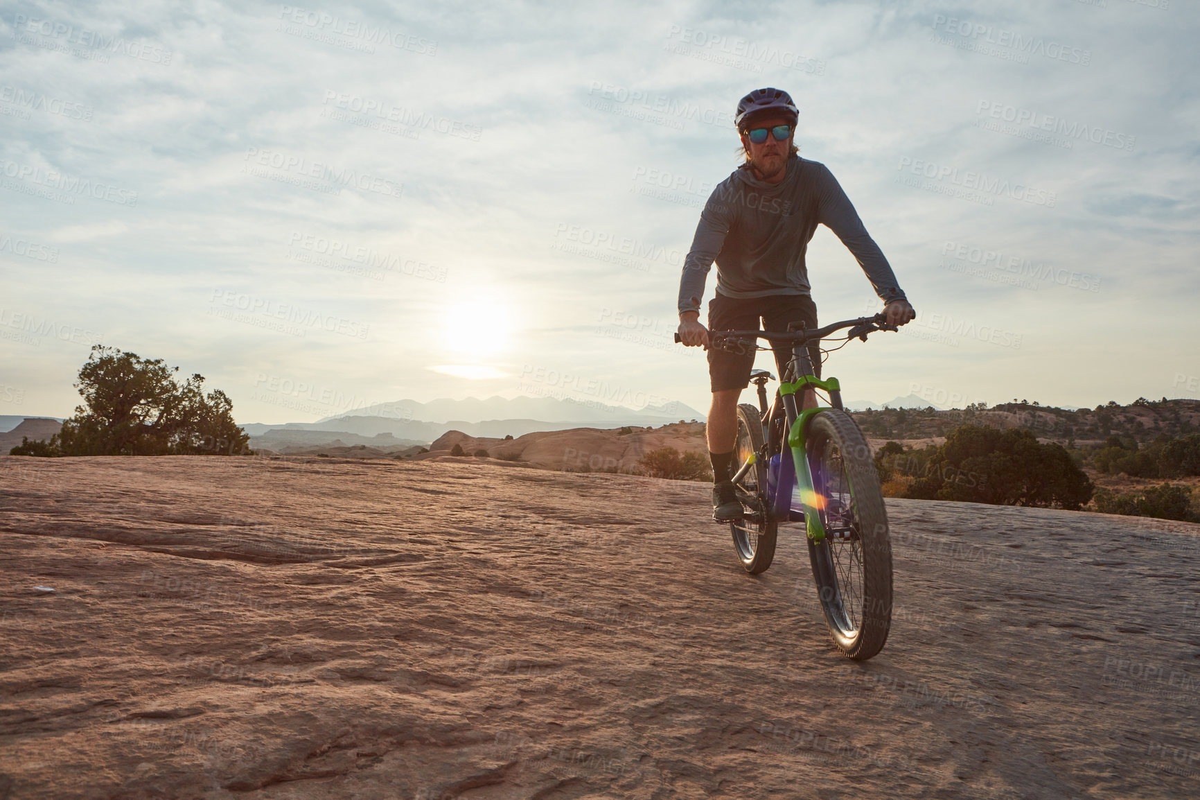 Buy stock photo Shot of a young man out mountain biking during the day