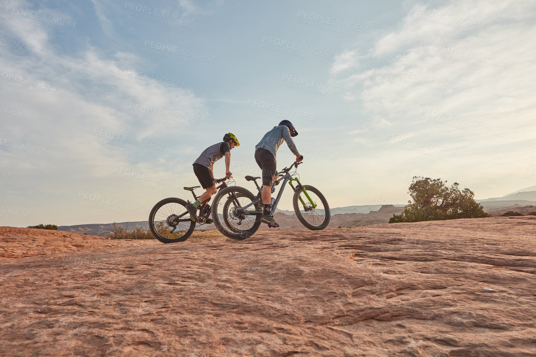 Buy stock photo Full length shot of two men out mountain biking together during the day