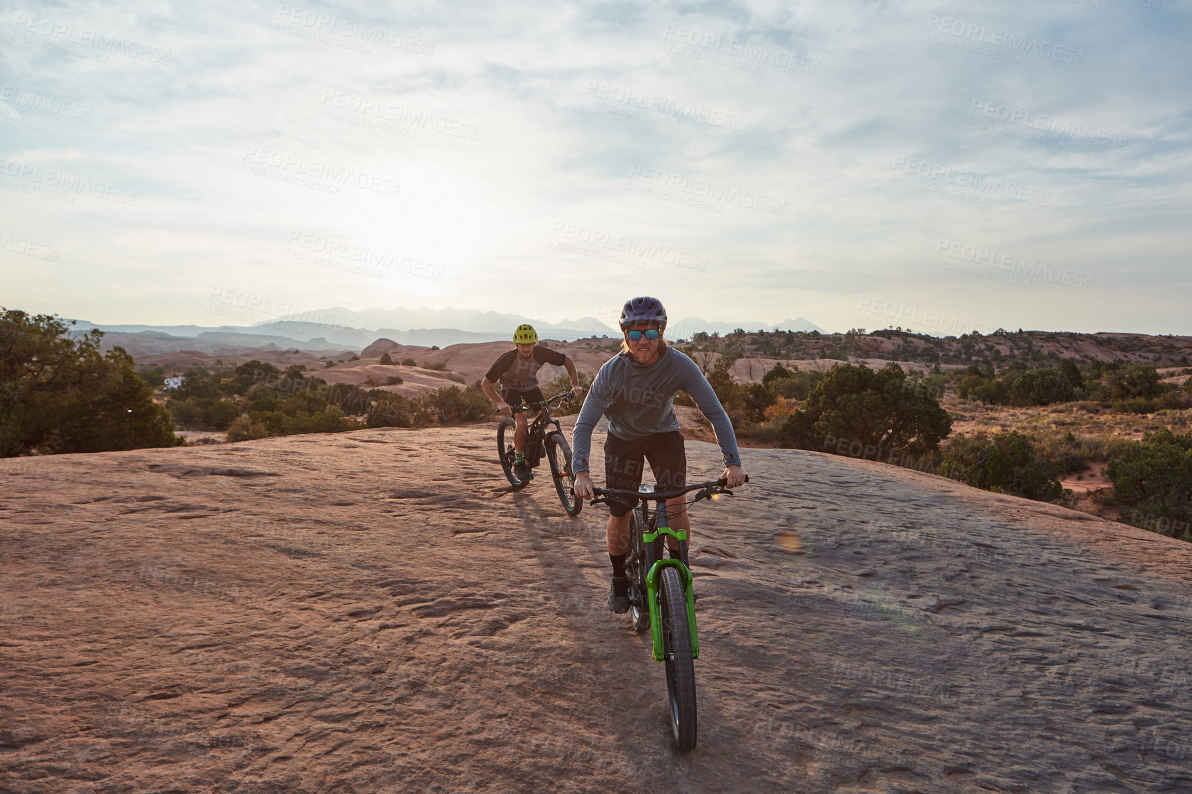 Buy stock photo Full length shot of two men out mountain biking together during the day