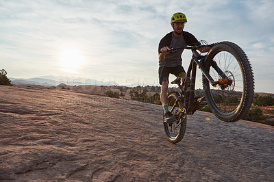 Buy stock photo Shot of a young man out mountain biking during the day