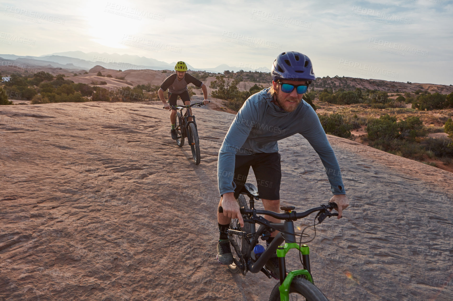 Buy stock photo Full length shot of two men out mountain biking together during the day