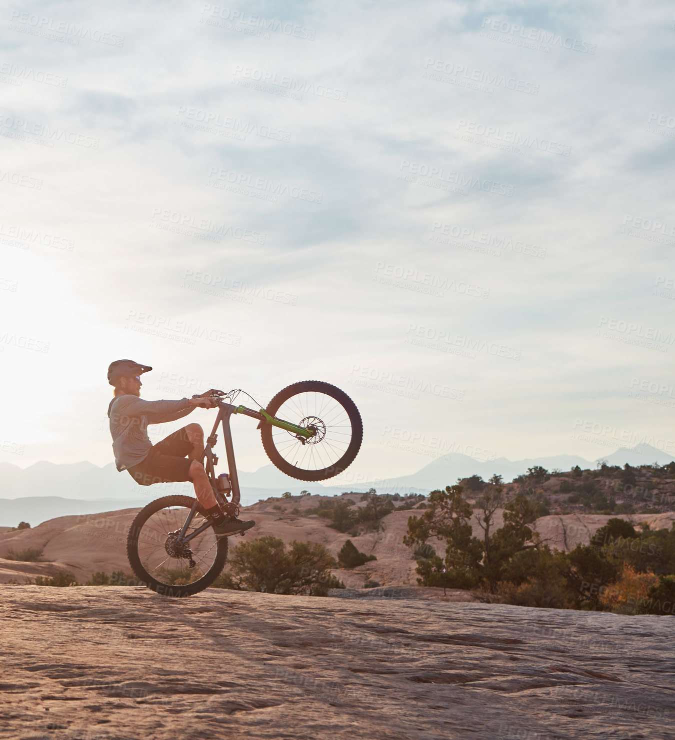 Buy stock photo Shot of a young man out mountain biking during the day