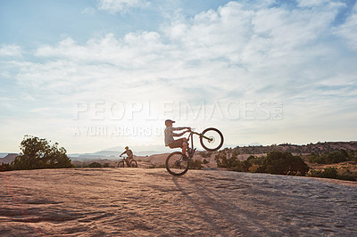 Buy stock photo Shot of a young man out mountain biking during the day