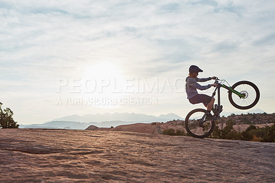 Buy stock photo Shot of a young man out mountain biking during the day