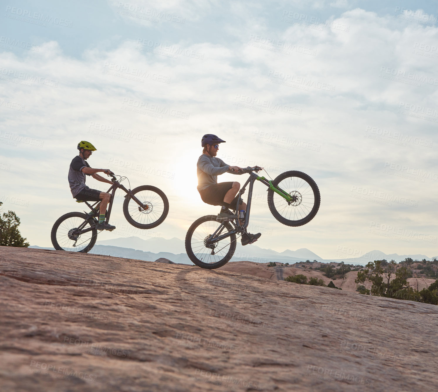 Buy stock photo Full length shot of two men out mountain biking together during the day