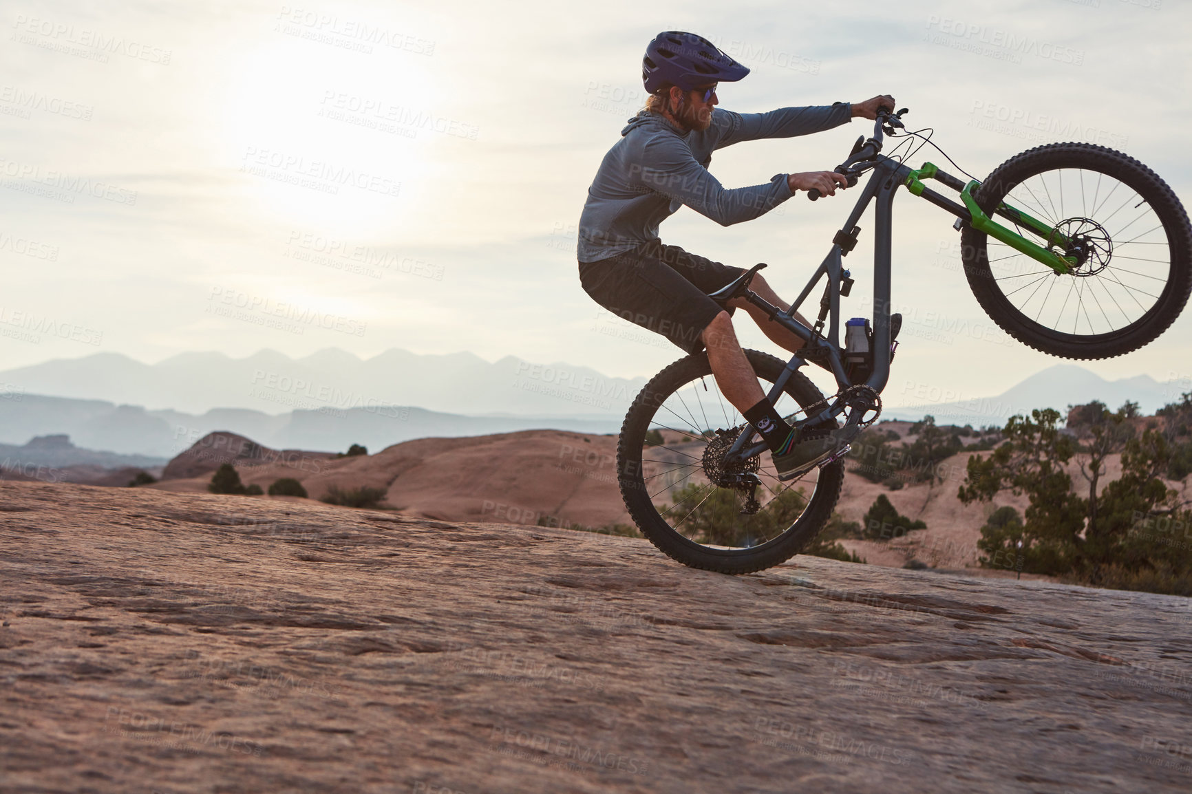 Buy stock photo Shot of a young man out mountain biking during the day