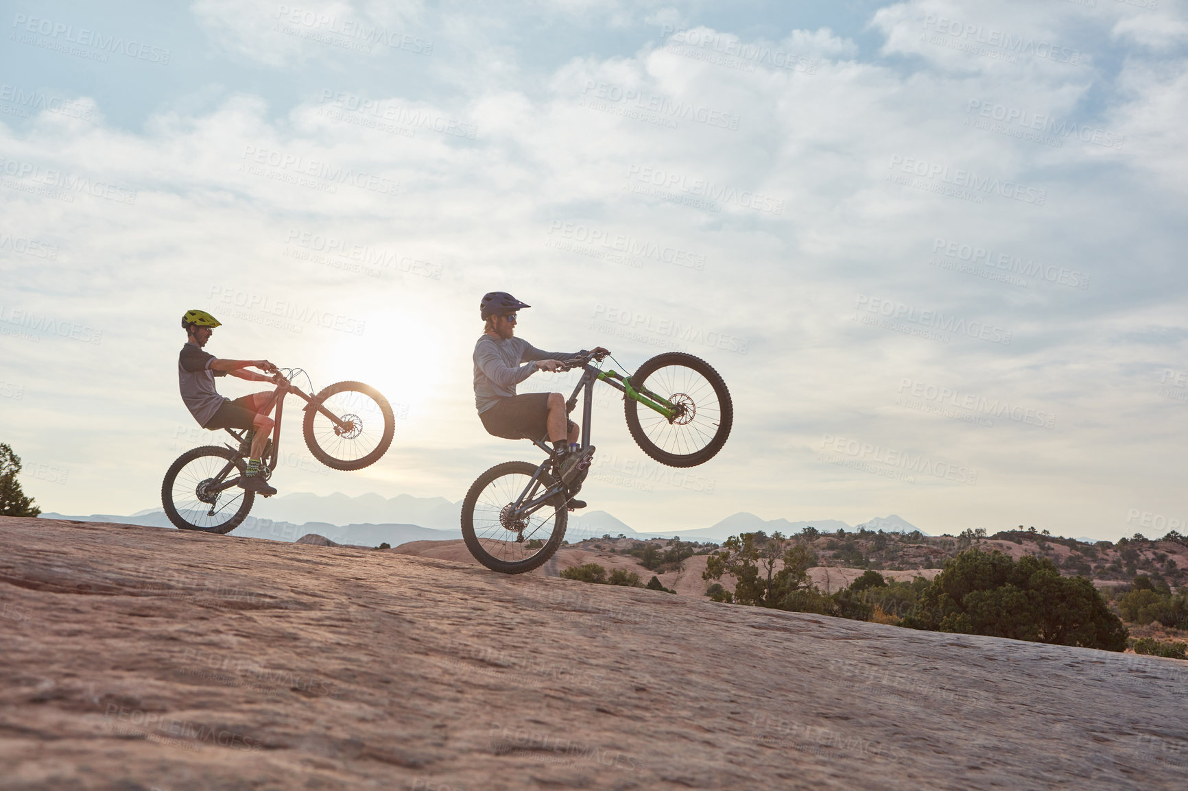 Buy stock photo Full length shot of two men out mountain biking together during the day