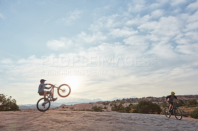 Buy stock photo Shot of a young man out mountain biking during the day