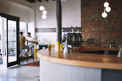 Buy stock photo Shot of two young men sitting together in a coffee shop