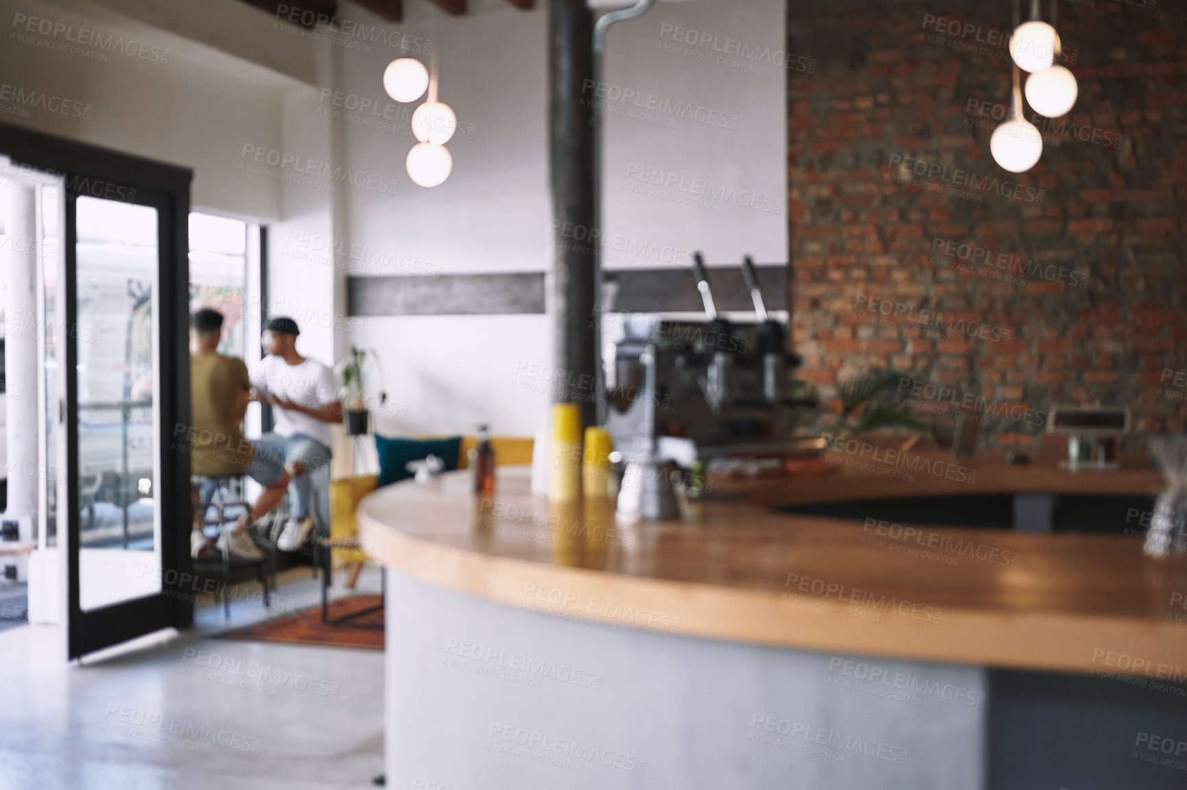 Buy stock photo Shot of two young men sitting together in a coffee shop