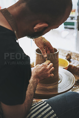 Buy stock photo Shot of an unrecognisable man working with clay in a pottery studio
