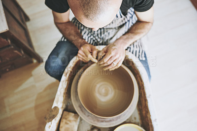 Buy stock photo Shot of an unrecognisable man working with clay in a pottery studio