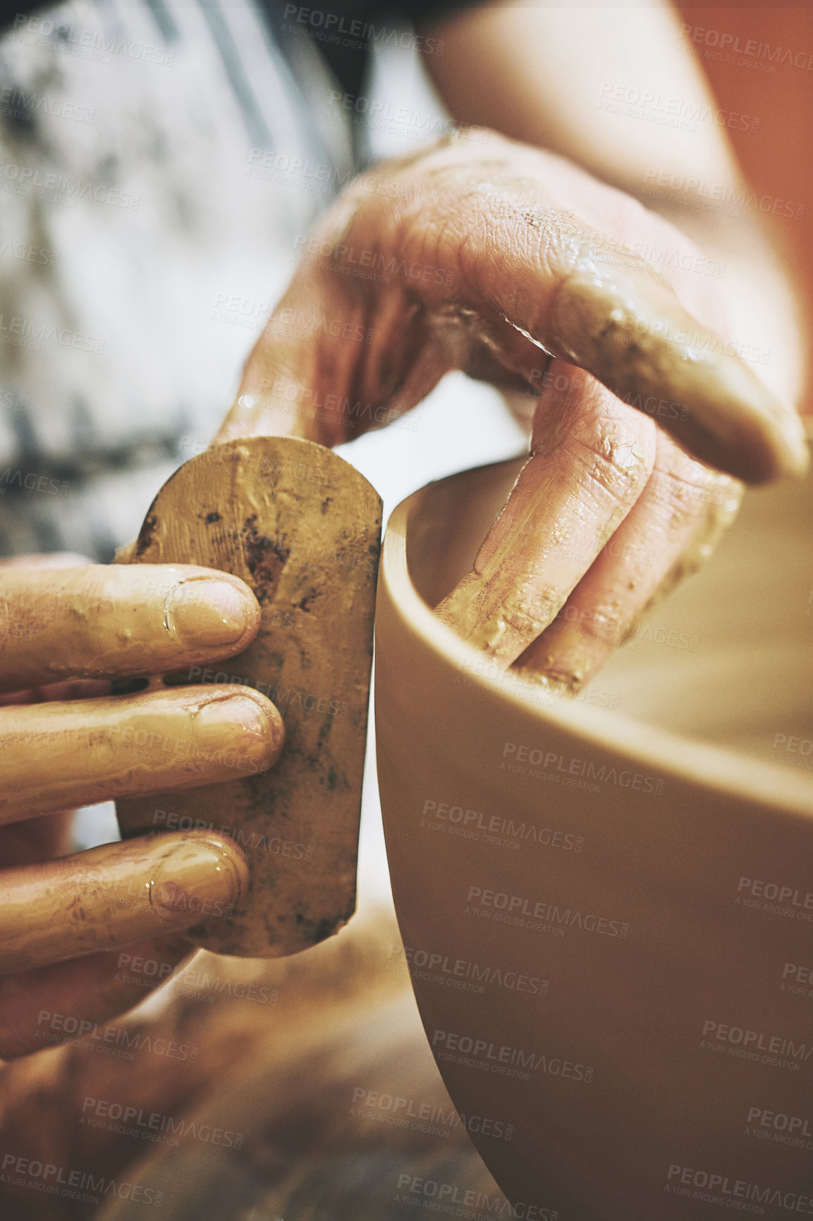 Buy stock photo Shot of an unrecognisable man working with clay in a pottery studio