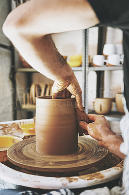 Buy stock photo Shot of an unrecognisable man working with clay in a pottery studio