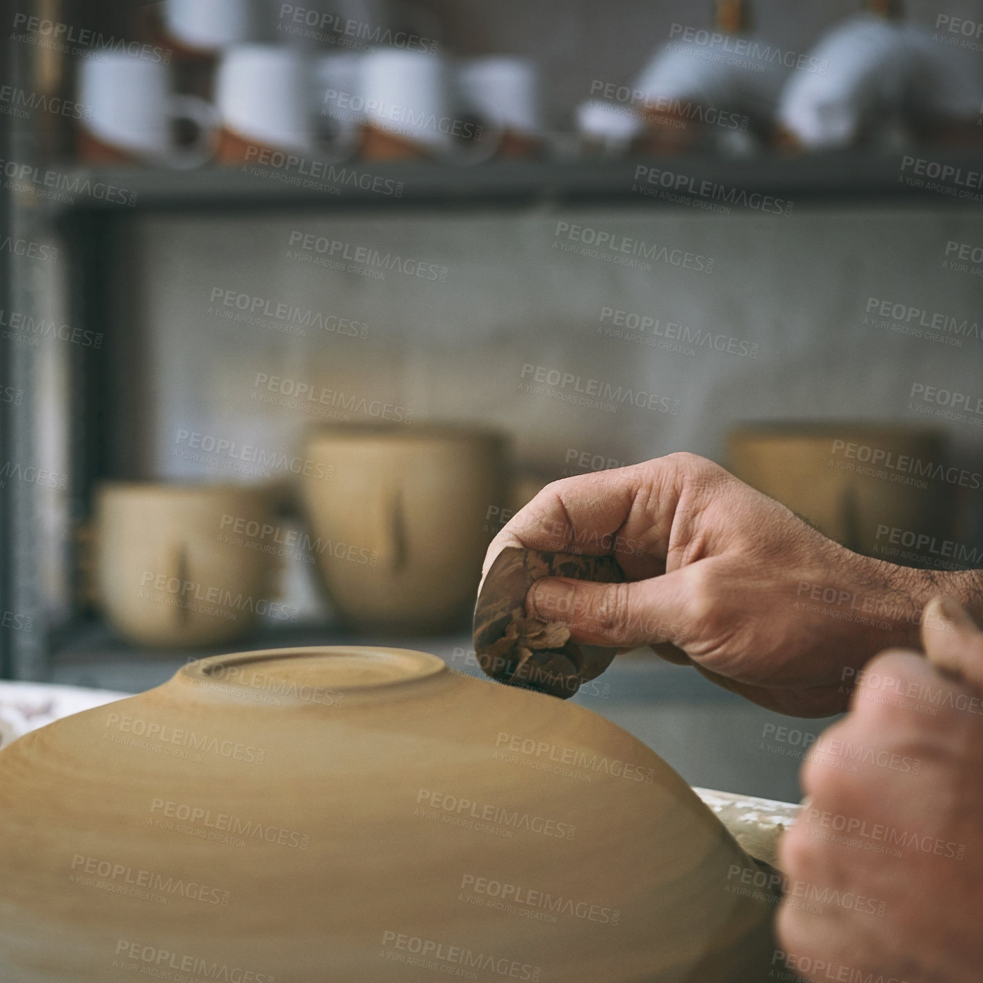 Buy stock photo Shot of an unrecognisable man working with clay in a pottery studio