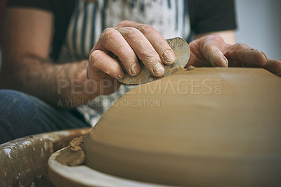 Buy stock photo Shot of an unrecognisable man working with clay in a pottery studio