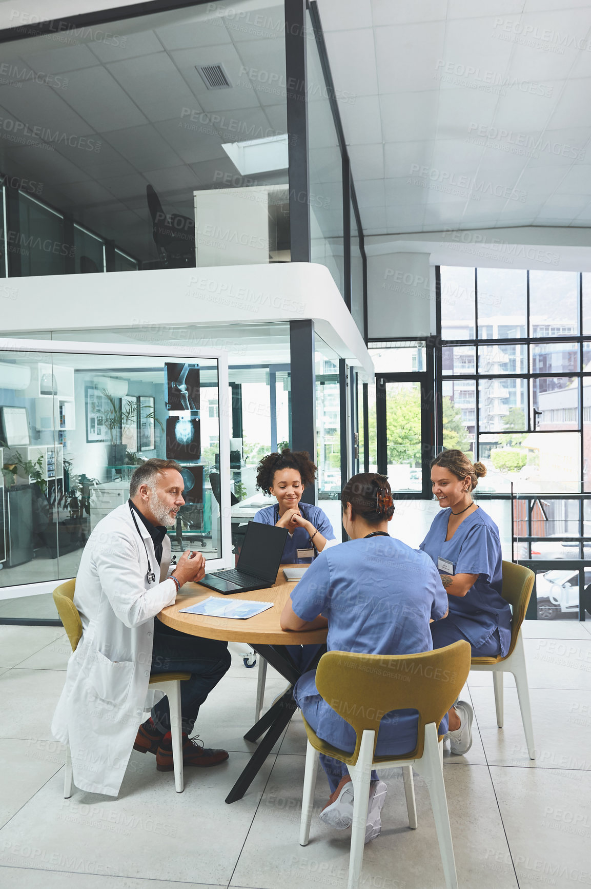 Buy stock photo Shot of a team of doctors having a meeting in a hospital