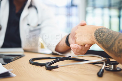 Buy stock photo Closeup shot of doctors shaking hands during a meeting in a hospital