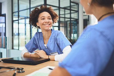 Buy stock photo Shot of a young doctor having a meeting with a colleague in a hospital