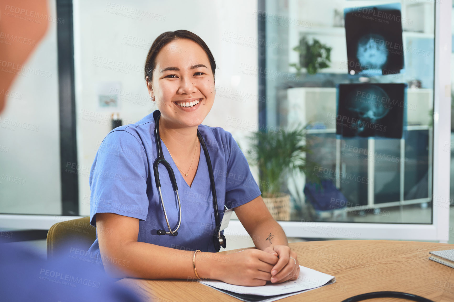 Buy stock photo Shot of a young doctor having a meeting with a colleague in a hospital