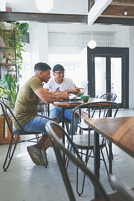 Buy stock photo Full length shot of two handsome friends sitting together in a coffeeshop and using technology during a discussion