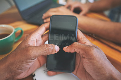 Buy stock photo Cropped shot of two unrecognizable friends sitting together and using technology in a coffeeshop