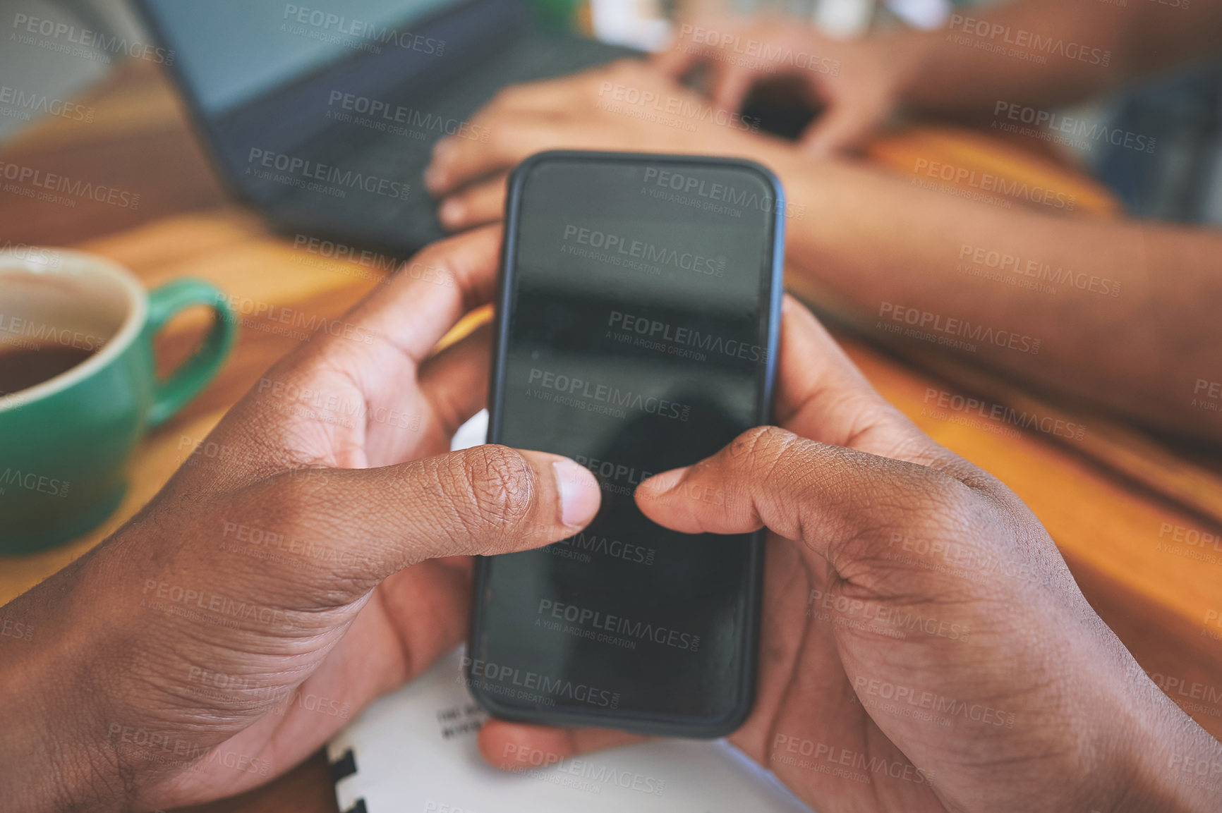 Buy stock photo Cropped shot of two unrecognizable friends sitting together and using technology in a coffeeshop