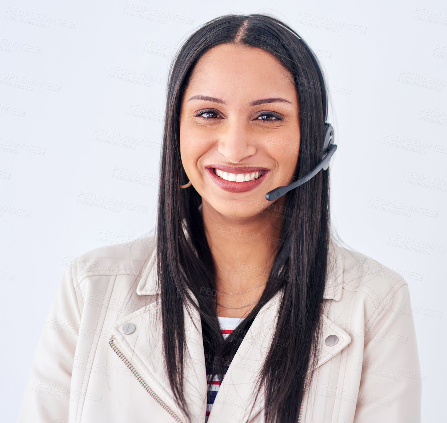 Buy stock photo Studio portrait of a young woman wearing a headset against a white background