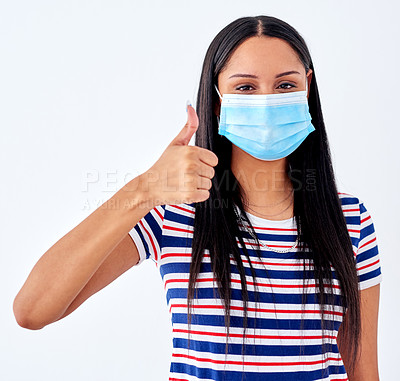 Buy stock photo Woman, mask and thumbs up in studio with covid, portrait and safety regulation for health, healthcare and wellness. Patient, vaccine and healthy for medical results or compliance on white background