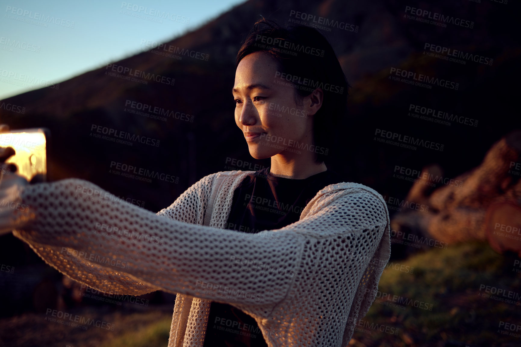 Buy stock photo Hiking, selfie and Asian woman on mountain with sunset, smile and relax on holiday adventure. Digital photography, outdoor trekking and happy girl with natural view, sunshine and memory on vacation.