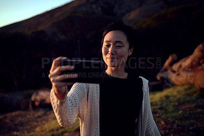 Buy stock photo Hiking, selfie and Asian woman on mountain with smile, nature and relax on holiday adventure. Digital photography, outdoor trekking and happy girl with natural view, travel and memory on vacation.