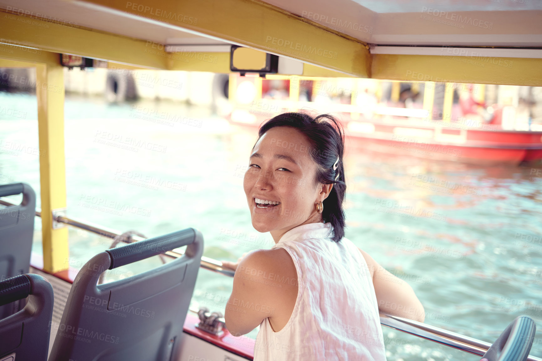 Buy stock photo Cropped portrait of an attractive young woman exploring the city alone on a ferry during the day