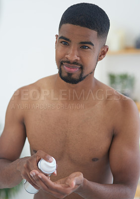 Buy stock photo Cropped shot of a handsome young man standing and using his bathroom mirror to shave in the morning