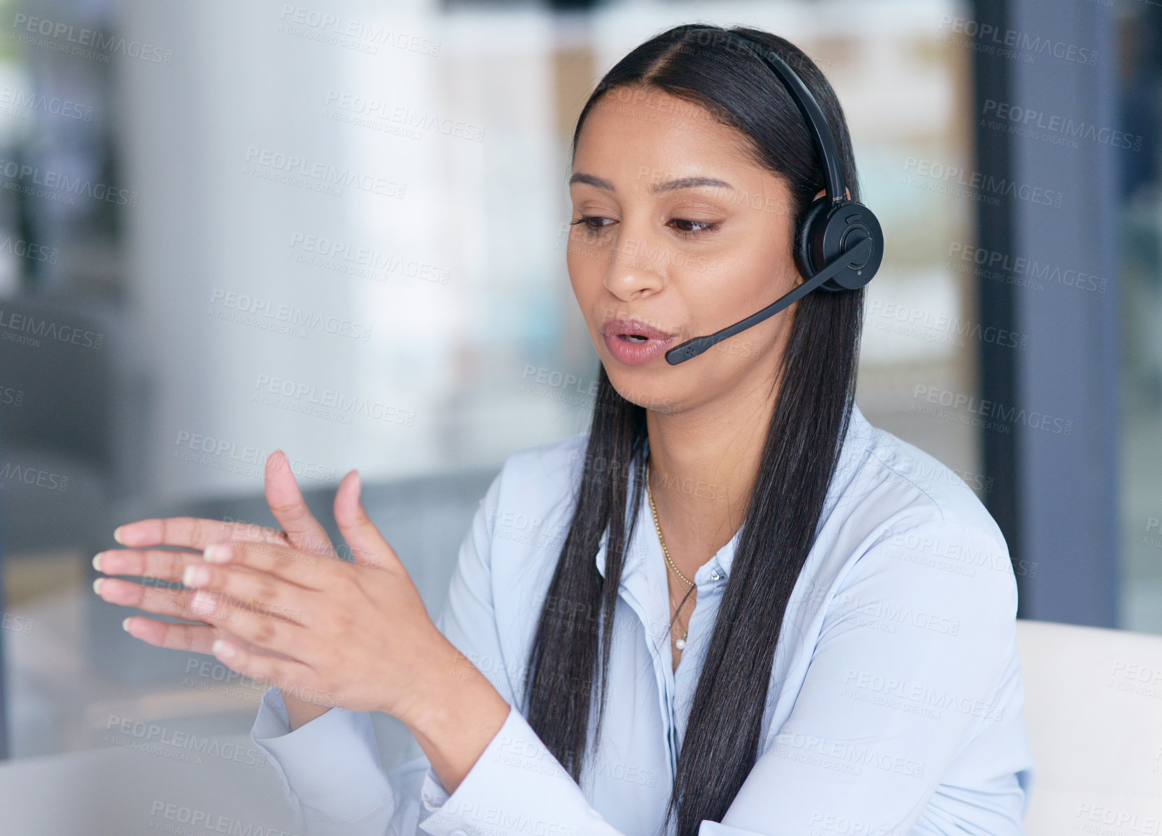 Buy stock photo Shot of a young call centre agent working in an office