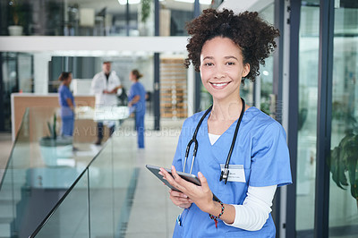 Buy stock photo Cropped portrait of an attractive young nurse standing and using a digital tablet in the clinic