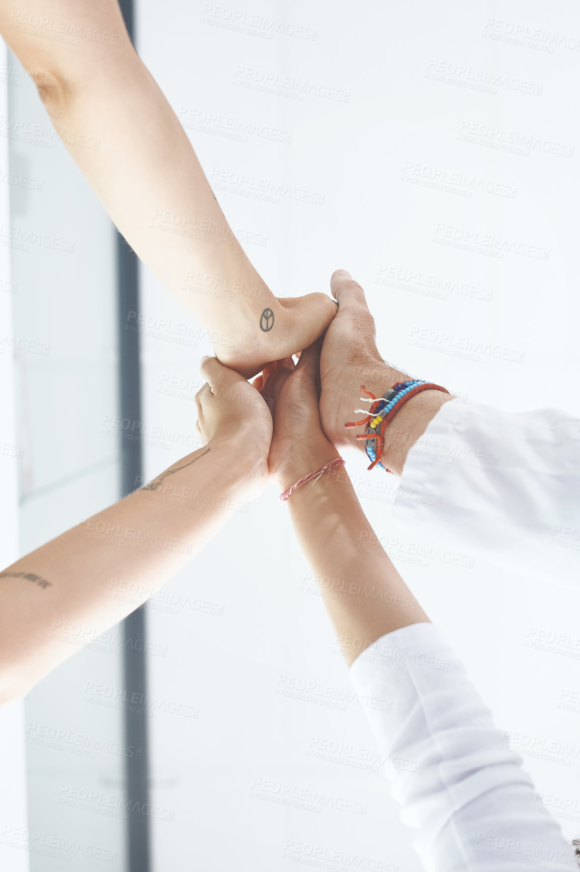 Buy stock photo Low angle shot of an unrecognizable group of healthcare professionals standing and giving each other a high five