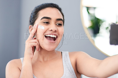 Buy stock photo Beauty, lotion and selfie of woman in bathroom for cosmetics, profile picture or vitamin c. Face, collagen and skincare with happy influencer person in apartment for antiaging wellness routine