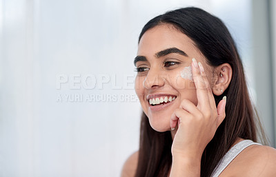 Buy stock photo Shot of a beautiful young woman applying her skincare