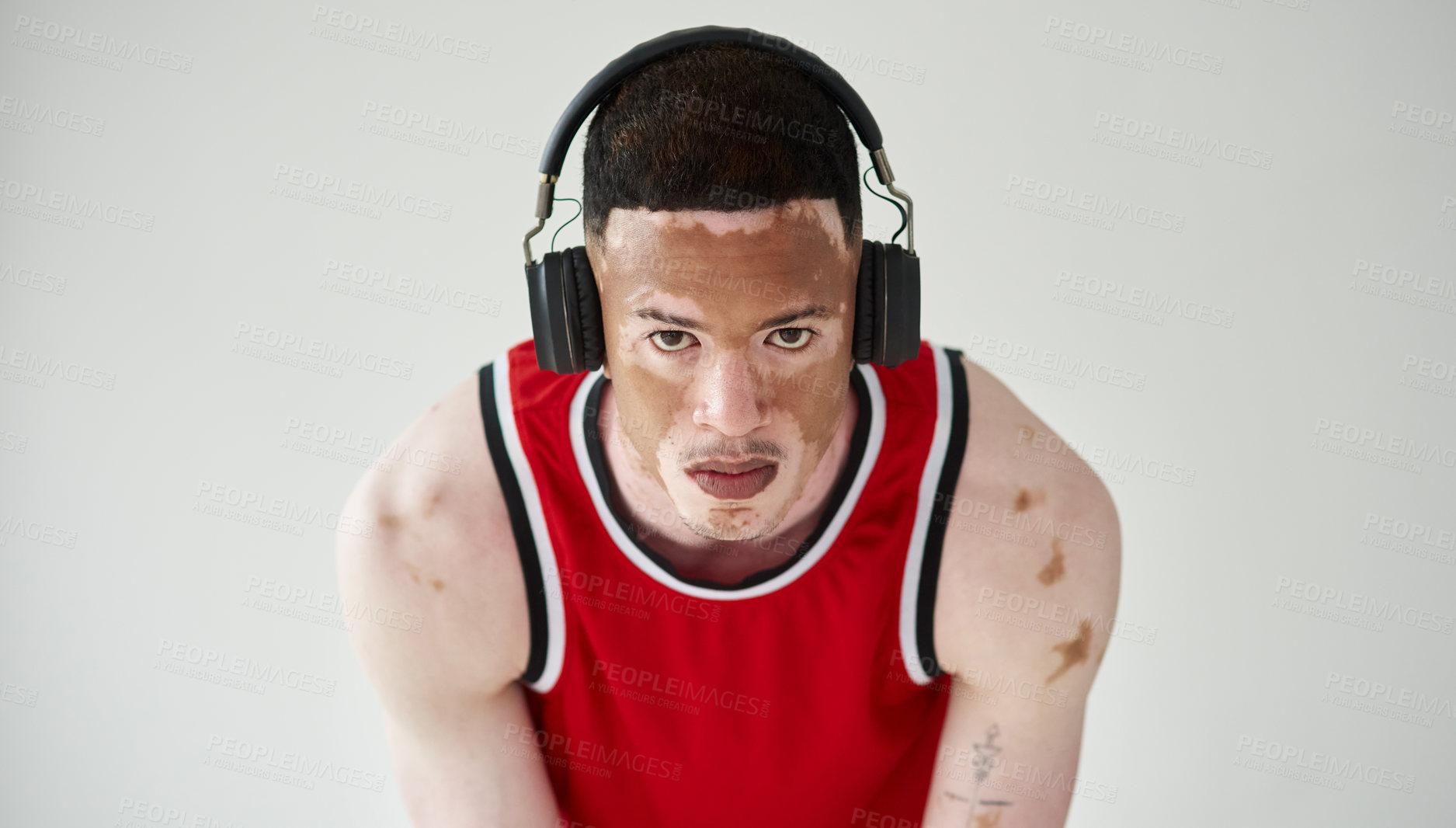 Buy stock photo Man, portrait and fitness with headphones in studio for music listening, vitiligo and workout. Unique skin, basketball player and health by white background with headset for training body and audio