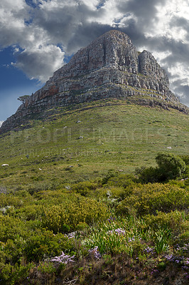 Buy stock photo The beautiful mountain peak of Lion's Head in Cape Town with a cloudy blue sky on a winter afternoon. Peaceful and scenic view of a summit with pasture outdoors in nature on an overcast summer day