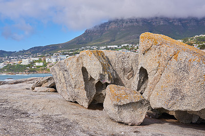 Buy stock photo Boulders on the rocky coast of Western Cape, South Africa, Landscape view of a beautiful mountain and seashore in Cape Town. Natural seaside environment in a popular tourist location for a holiday