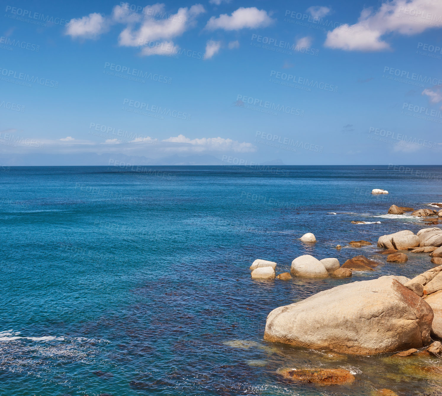 Buy stock photo The landscape of a tropical holiday destination. Beautiful rocky beach with a cloudy blue sky background on a summer day with copy space. Seascape with large rocks and calm water during spring. 