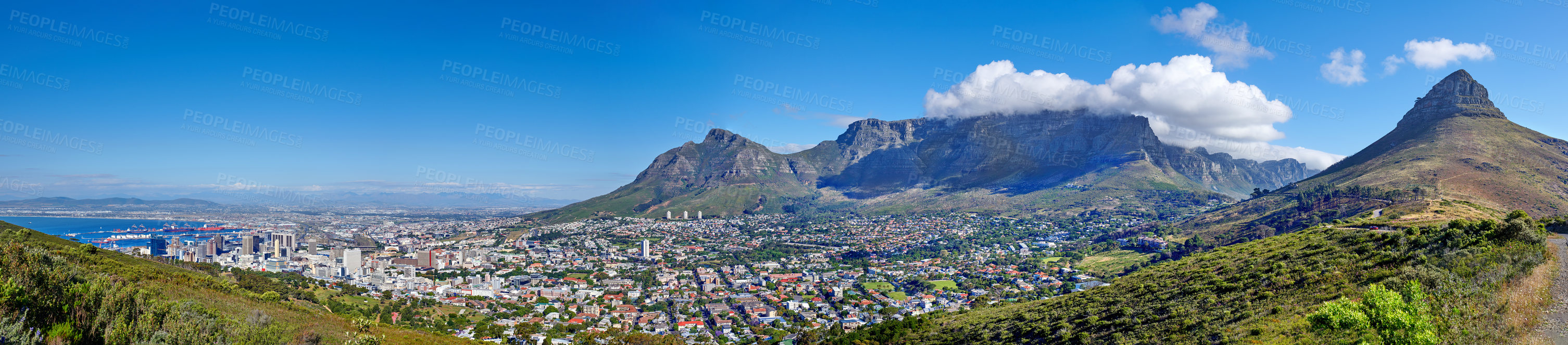 Buy stock photo Panoramic scene of Cape Town, South Africa. Table Mountain, Lion's Head and Signal Hill against a blue sky background, overlooking the city. Aerial view of the urban and natural environments